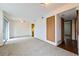 Open-concept living room featuring carpet, patio doors, and a view of the kitchen at 1301 S Cathay Ct # 104, Aurora, CO 80017