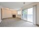 Spacious living room with a fireplace, carpet, and sliding doors to a patio at 1301 S Cathay Ct # 104, Aurora, CO 80017