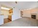 Living room features fireplace, laundry closet, open floorplan and carpet at 1301 S Cathay Ct # 104, Aurora, CO 80017