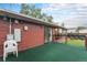 Cozy back deck with green outdoor carpet and access to the backyard at 7644 Wyandot St, Denver, CO 80221