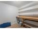 Unfinished basement with a wooden workbench and shelving for storage at 7644 Wyandot St, Denver, CO 80221