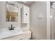 Cozy bathroom with a mirrored vanity, storage cabinet, and walk-in shower at 7644 Wyandot St, Denver, CO 80221
