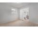 Empty bedroom with neutral carpet, lots of light, and an open doorway at 7644 Wyandot St, Denver, CO 80221