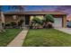 Charming brick home featuring a well-manicured lawn and mature landscaping at 7644 Wyandot St, Denver, CO 80221