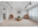 Comfortable living room featuring neutral carpet, track lighting, and cozy seating at 7644 Wyandot St, Denver, CO 80221