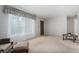 Spacious living room featuring plush carpeting and a large window at 7644 Wyandot St, Denver, CO 80221