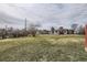 Spacious backyard featuring a well-maintained lawn, mature trees, and a charming single-Gathering home with a brick chimney at 170 S Fenton St, Lakewood, CO 80226