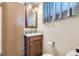 Bathroom with wooden vanity, modern faucet, mirror and decorative tiling at 170 S Fenton St, Lakewood, CO 80226