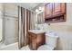 Bathroom features tile flooring, a wood vanity and a shower with a curtain at 170 S Fenton St, Lakewood, CO 80226