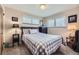 Bedroom features carpet, a plaid bedspread and dresser near a window at 170 S Fenton St, Lakewood, CO 80226