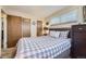 Bedroom features carpet, a plaid bedspread and dresser near closets at 170 S Fenton St, Lakewood, CO 80226