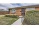 Welcoming brick home featuring a decorative security door and meticulously manicured shrubbery at 170 S Fenton St, Lakewood, CO 80226