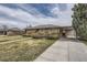 Charming brick home with a covered carport, mature landscaping, and a well-maintained front lawn at 170 S Fenton St, Lakewood, CO 80226