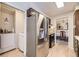Kitchen with stainless steel refrigerator, adjacent laundry area, and view into the dining room at 170 S Fenton St, Lakewood, CO 80226