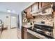 Functional kitchen with stainless steel appliances, mosaic backsplash, and a clean white door at 170 S Fenton St, Lakewood, CO 80226