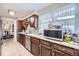 Well-lit kitchen featuring stainless steel appliances, light countertops, and ample cabinet space at 170 S Fenton St, Lakewood, CO 80226