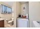 Laundry area with washing machine, a toilet, and shelving at 170 S Fenton St, Lakewood, CO 80226