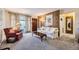 Comfortable living room with neutral carpeting, wood paneling, and a bright window at 170 S Fenton St, Lakewood, CO 80226