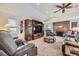 Open living room featuring a built-in entertainment center, brick fireplace, and vaulted ceilings at 170 S Fenton St, Lakewood, CO 80226