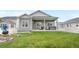A spacious backyard featuring a well-maintained lawn and a covered patio with a hot tub at 5597 Pinto Valley St, Parker, CO 80134