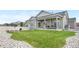 Well-manicured lawn with stone landscaping and a covered patio, ideal for outdoor entertaining at 5597 Pinto Valley St, Parker, CO 80134