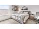 This bedroom includes a large window, plaid comforter, mountain art, and a wooden nightstand at 5597 Pinto Valley St, Parker, CO 80134