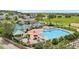 Aerial view of a community pool featuring a large pool, splash pool, and covered seating areas at 5597 Pinto Valley St, Parker, CO 80134