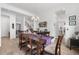 Bright dining room with a hardwood floor, dining table with six chairs, modern lighting, and decor at 5597 Pinto Valley St, Parker, CO 80134