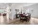 An open dining area is illuminated by natural light, complemented by contemporary decor and stylish wooden floors at 5597 Pinto Valley St, Parker, CO 80134