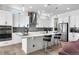 Bright and open kitchen with white cabinets, stainless steel appliances and large island at 5597 Pinto Valley St, Parker, CO 80134