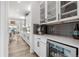 Bright kitchen showcasing white cabinets and a beverage fridge at 5597 Pinto Valley St, Parker, CO 80134