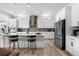Bright, open kitchen with white cabinets, stainless appliances, large island with bar seating at 5597 Pinto Valley St, Parker, CO 80134