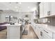 Bright kitchen showcasing white cabinets and a spacious island with seating at 5597 Pinto Valley St, Parker, CO 80134