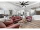 Bright living room featuring modern furnishings, a ceiling fan, and open layout at 5597 Pinto Valley St, Parker, CO 80134