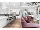 Open-concept living room showcasing kitchen, staircase, modern finishes and light wood floors at 5597 Pinto Valley St, Parker, CO 80134