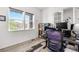 This office features natural light, modern desk, chair, storage cabinet, and a view to the neighborhood at 5597 Pinto Valley St, Parker, CO 80134
