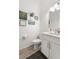 Bright powder room featuring a modern vanity with white cabinets, framed art, and neutral walls at 5597 Pinto Valley St, Parker, CO 80134