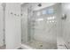 Luxurious shower with glass enclosure, multiple showerheads, and tiled walls at 5597 Pinto Valley St, Parker, CO 80134