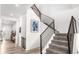 Modern staircase featuring metal railings, carpeted steps, and a two-story entrance at 5597 Pinto Valley St, Parker, CO 80134