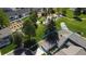 An aerial view of a townhome with mature trees, a community garden, and a putting green in a well-maintained community at 7172 S Vine Cir, Centennial, CO 80122