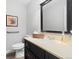 Bathroom features a black framed mirror above the modern vanity and sink, plus an efficient commode at 7172 S Vine Cir, Centennial, CO 80122