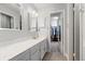 Updated bathroom featuring a spacious vanity and walk-in closet at 7172 S Vine Cir, Centennial, CO 80122