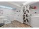 Practical bathroom featuring vinyl floor, shower with black and white curtain, and a washer and drier at 7172 S Vine Cir, Centennial, CO 80122