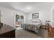 Bedroom featuring a bed, a sliding glass door to the backyard, and neutral colors at 7172 S Vine Cir, Centennial, CO 80122