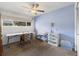 Bright bedroom featuring a ceiling fan, a large window, and ample space for furniture and relaxation at 7172 S Vine Cir, Centennial, CO 80122