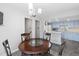 Bright dining area features an elegant chandelier and opens to the kitchen at 7172 S Vine Cir, Centennial, CO 80122