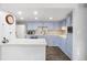 Well-lit kitchen features painted cabinets, white countertops, and stainless appliances at 7172 S Vine Cir, Centennial, CO 80122