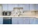 Close up shot of the kitchen, with blue cabinets, and white countertops at 7172 S Vine Cir, Centennial, CO 80122