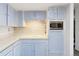 Contemporary kitchen with updated stainless steel appliances, and light blue cabinets at 7172 S Vine Cir, Centennial, CO 80122