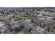 An aerial view shows the property nestled in a community with green spaces and tree-lined streets at 3600 S Pierce St # 5-202, Denver, CO 80235